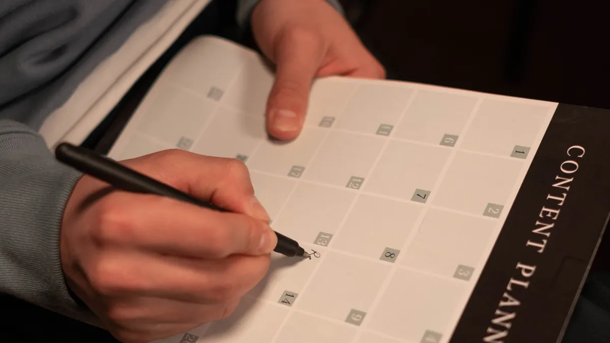 Content brief template for outsourced writing — Person Writing on a Calendar Planner