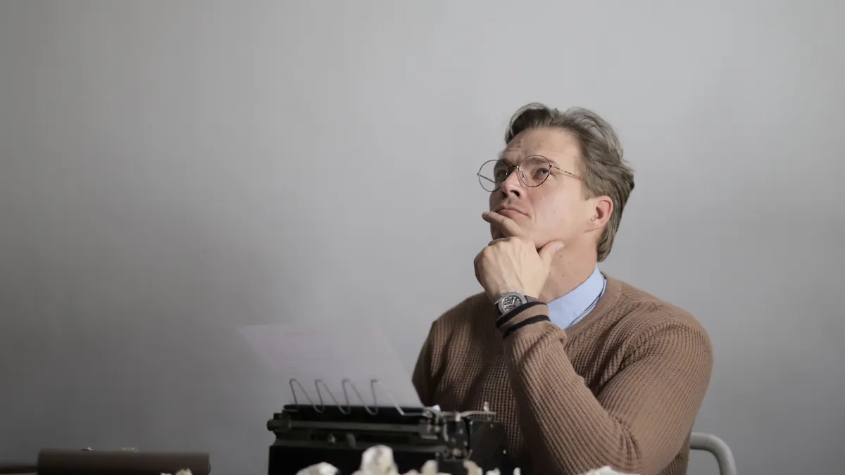 Freelance writer vs content writing agency: which should you hire? — Adult thoughtful writer creating new article