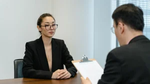 job interview across a desk with clipboard