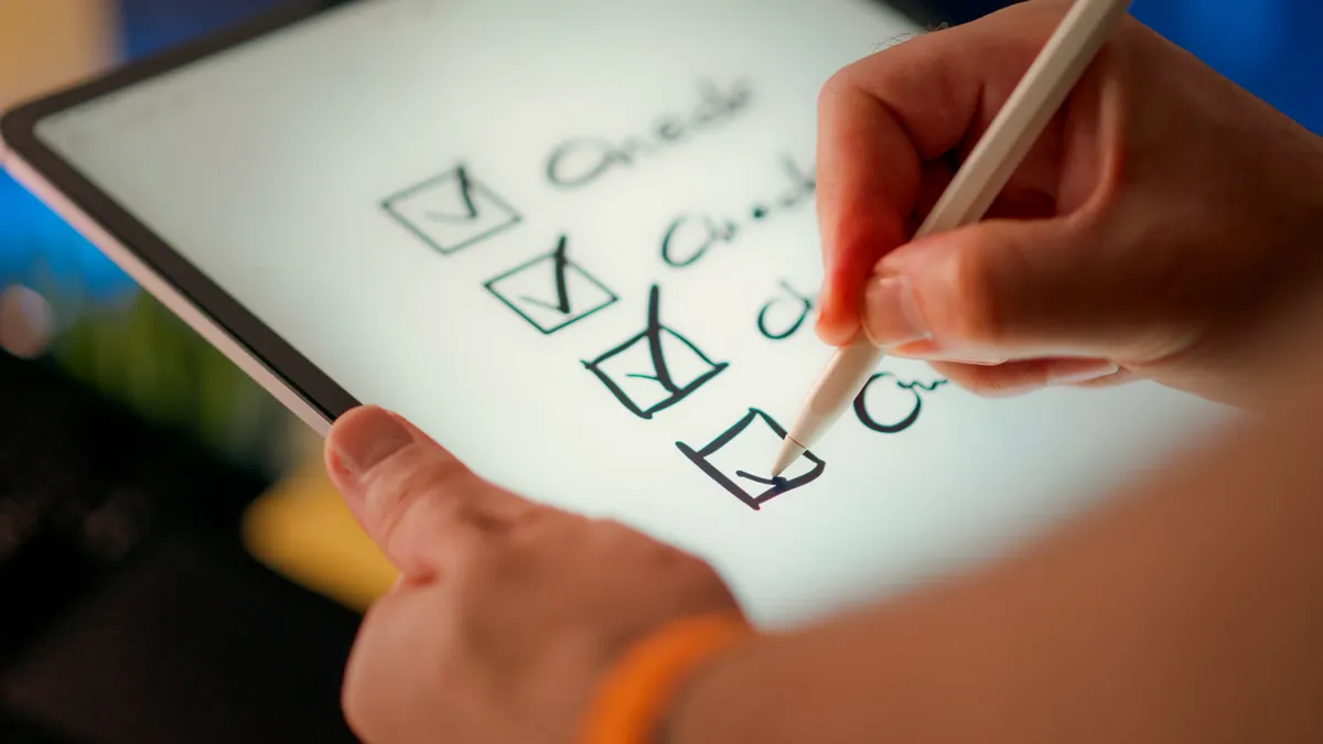 How to brief a content writer for SEO, thought leadership, and landing pages hand marking boxes on a tablet checklist