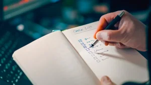 hand checking a written checklist