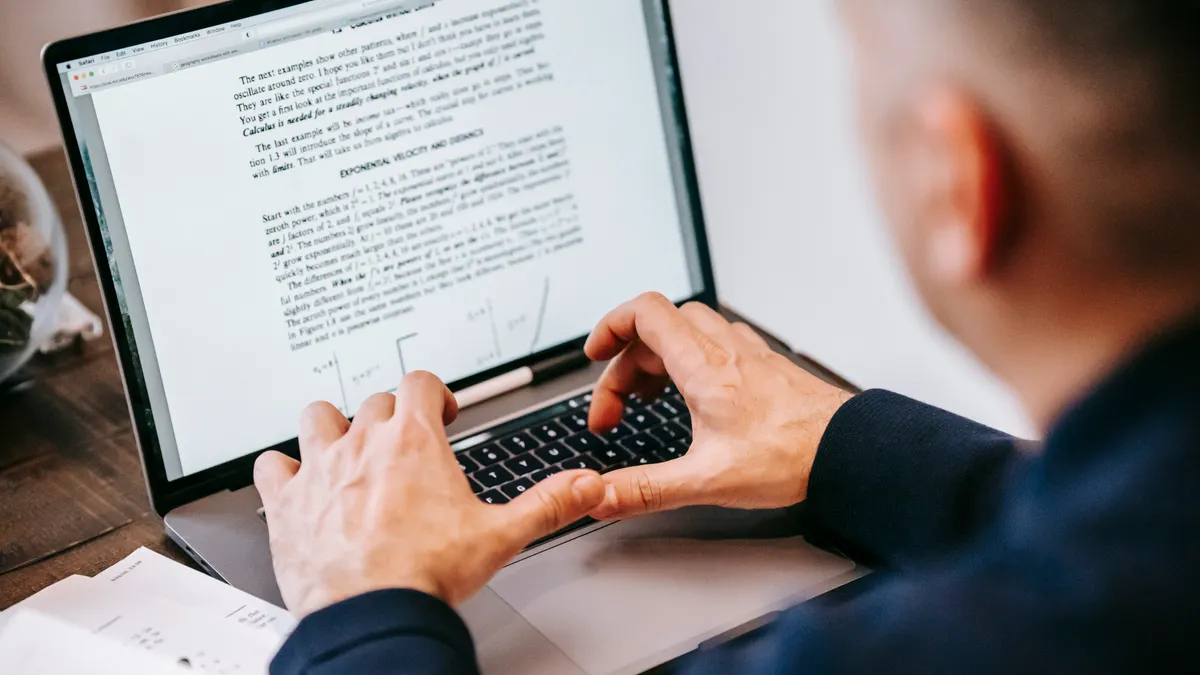 Person editing a document on a laptop