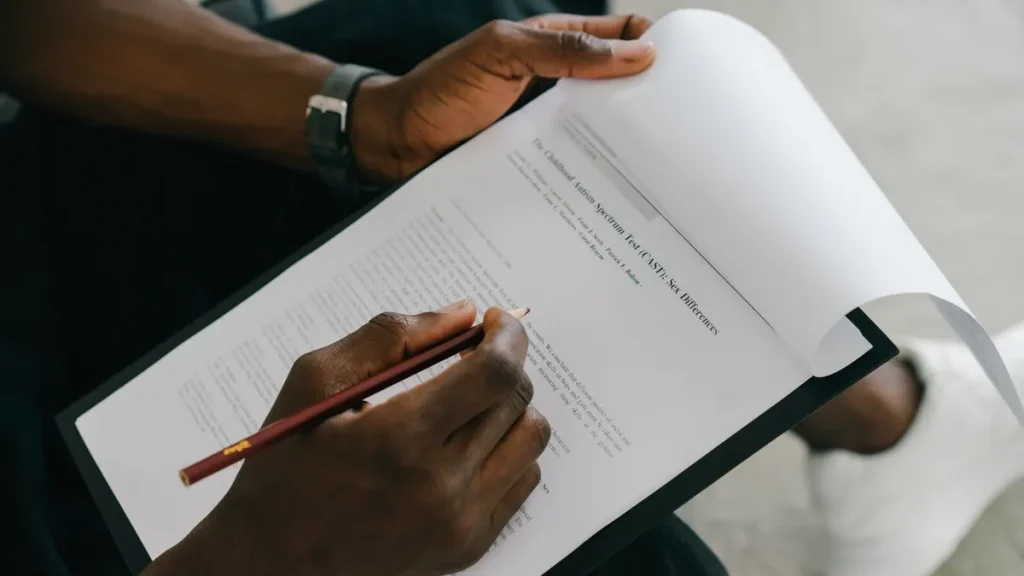 person marking revisions on a printed document