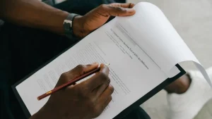 person marking revisions on a printed document