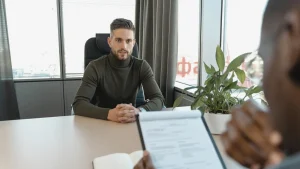 job interview with clipboard and candidate across a desk