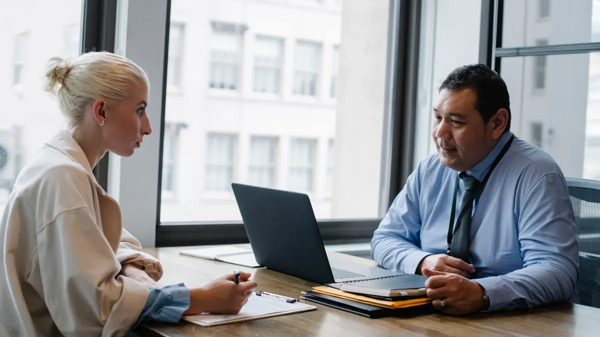 professional interview or hiring meeting across a table